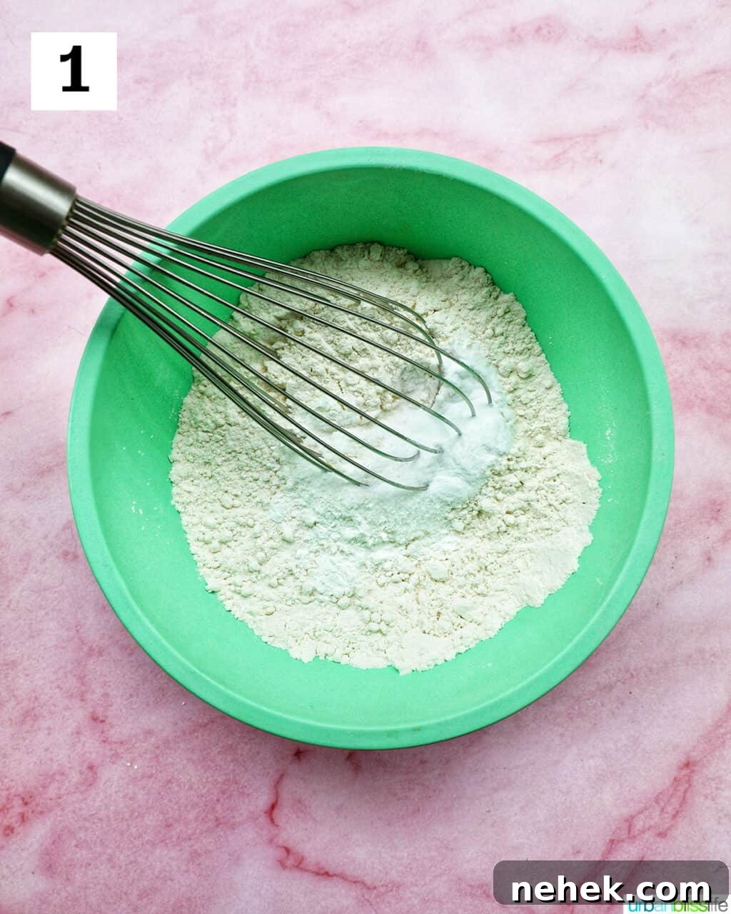 whisk and dry ingredients in a green bowl.