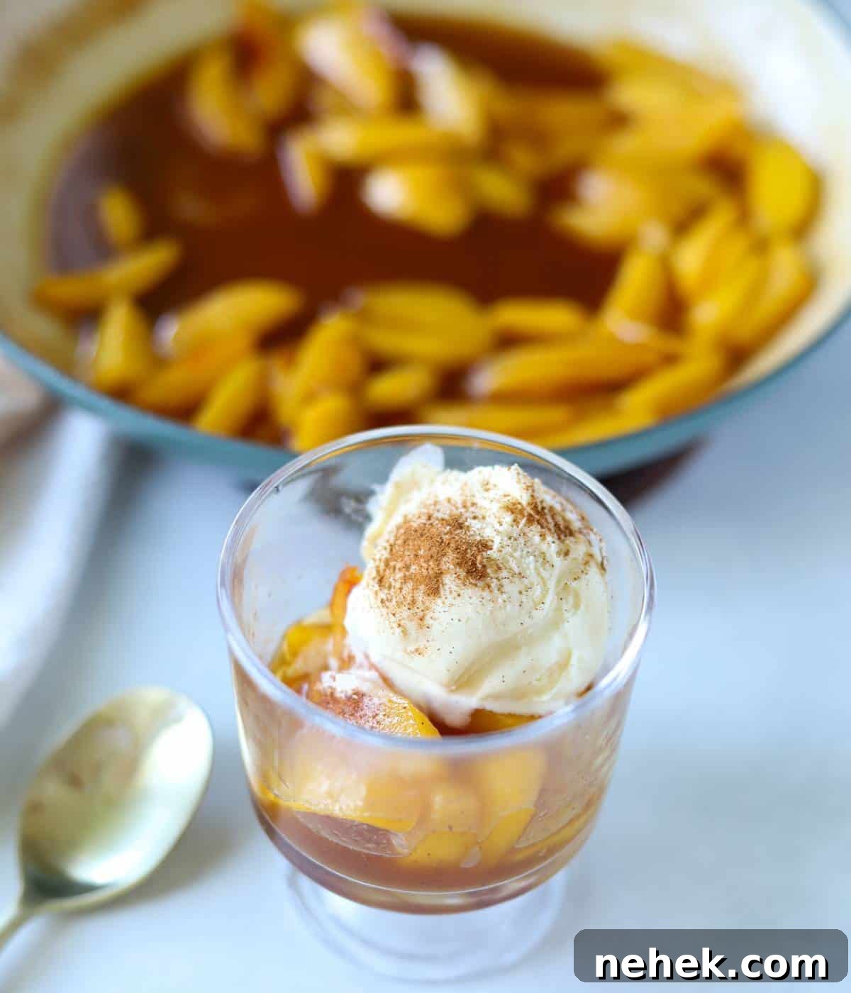 Skillet Caramelized Peaches with Brown Butter and Vanilla 9 Caramelized peaches in parfait cup topped with ice cream and cinnamon.