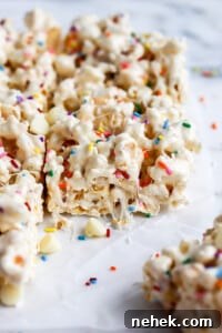 side view of marshmallow Rice Krispie treats on parchment paper