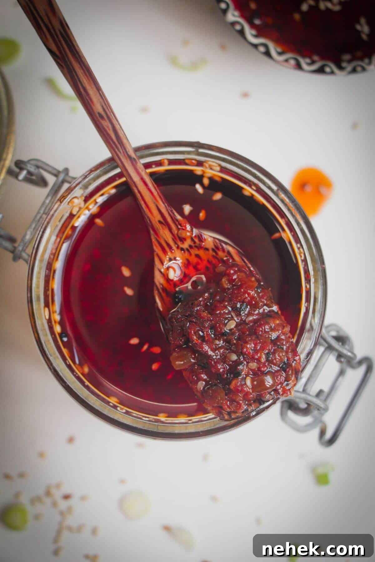 Wooden spoon in a jar of chilli oil.