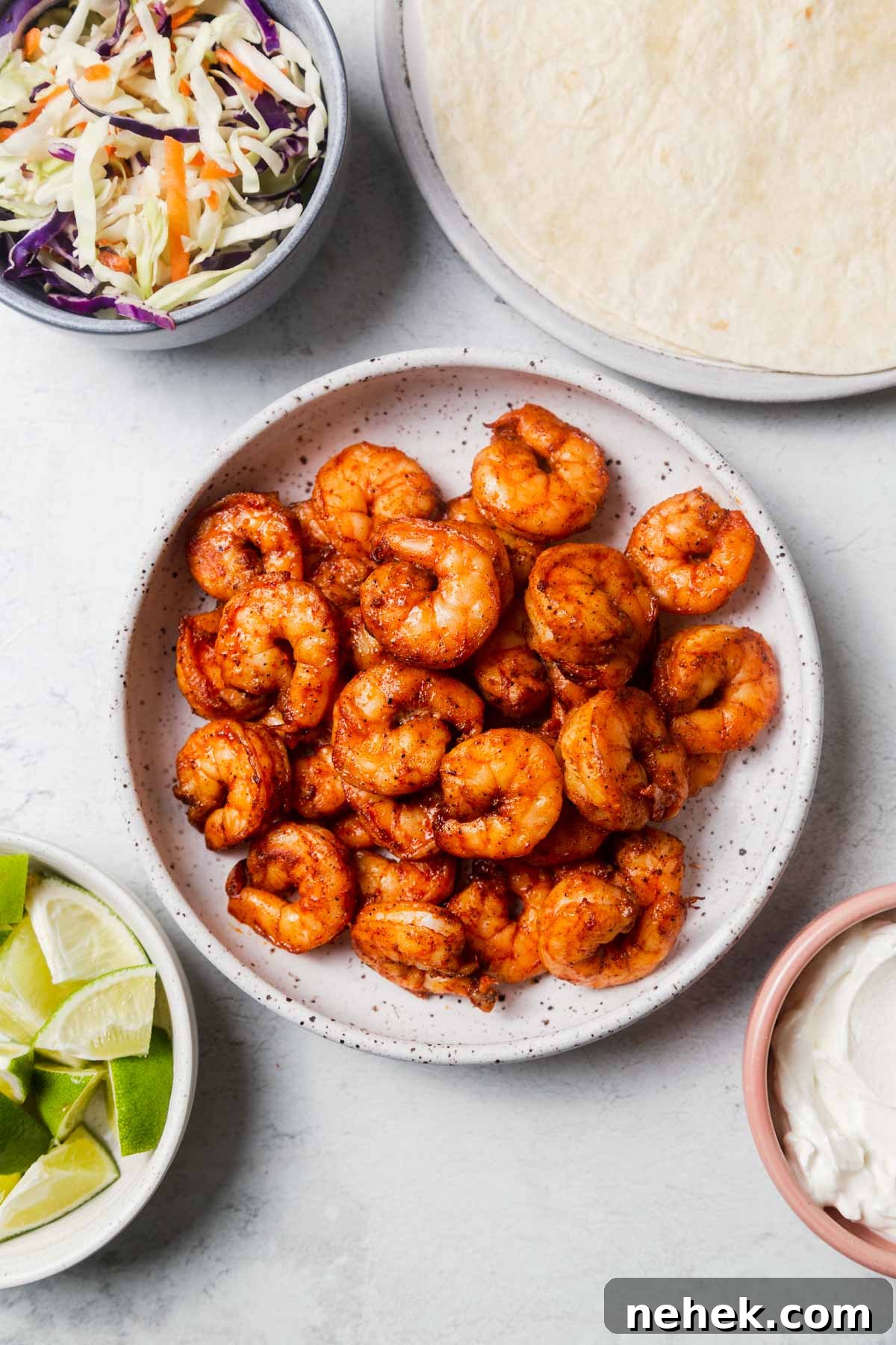 Crispy Air Fryer Shrimp Tacos with Lime Slaw 8 air fried shrimp with tortillas, sour cream and slaw for shrimp tacos.