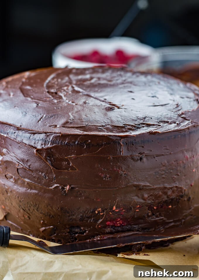 A four layer chocolate cake frosted with a crumb layer.
