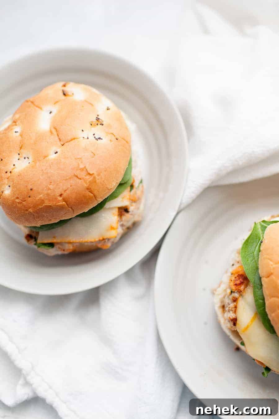 Sweet Potato and Turkey Burger Recipe for Flavorful Weeknights 3 Two sweet potato turkey burgers with spinach and cheese on white plates.