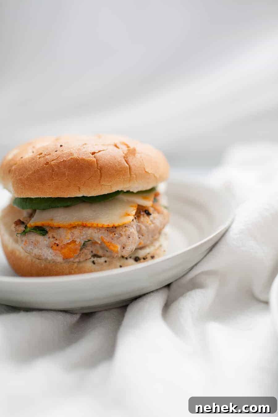 Sweet Potato and Turkey Burger Recipe for Flavorful Weeknights 4 A white plate with a Sweet Potato Turkey Burger on it.