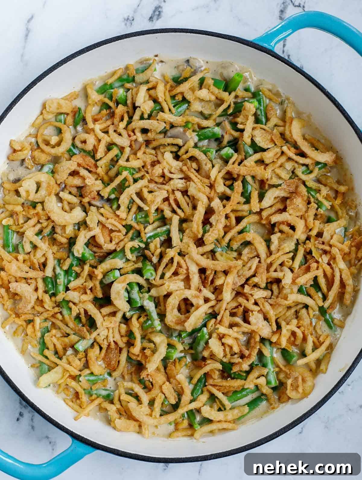 green been casserole topped with fried onions before baking