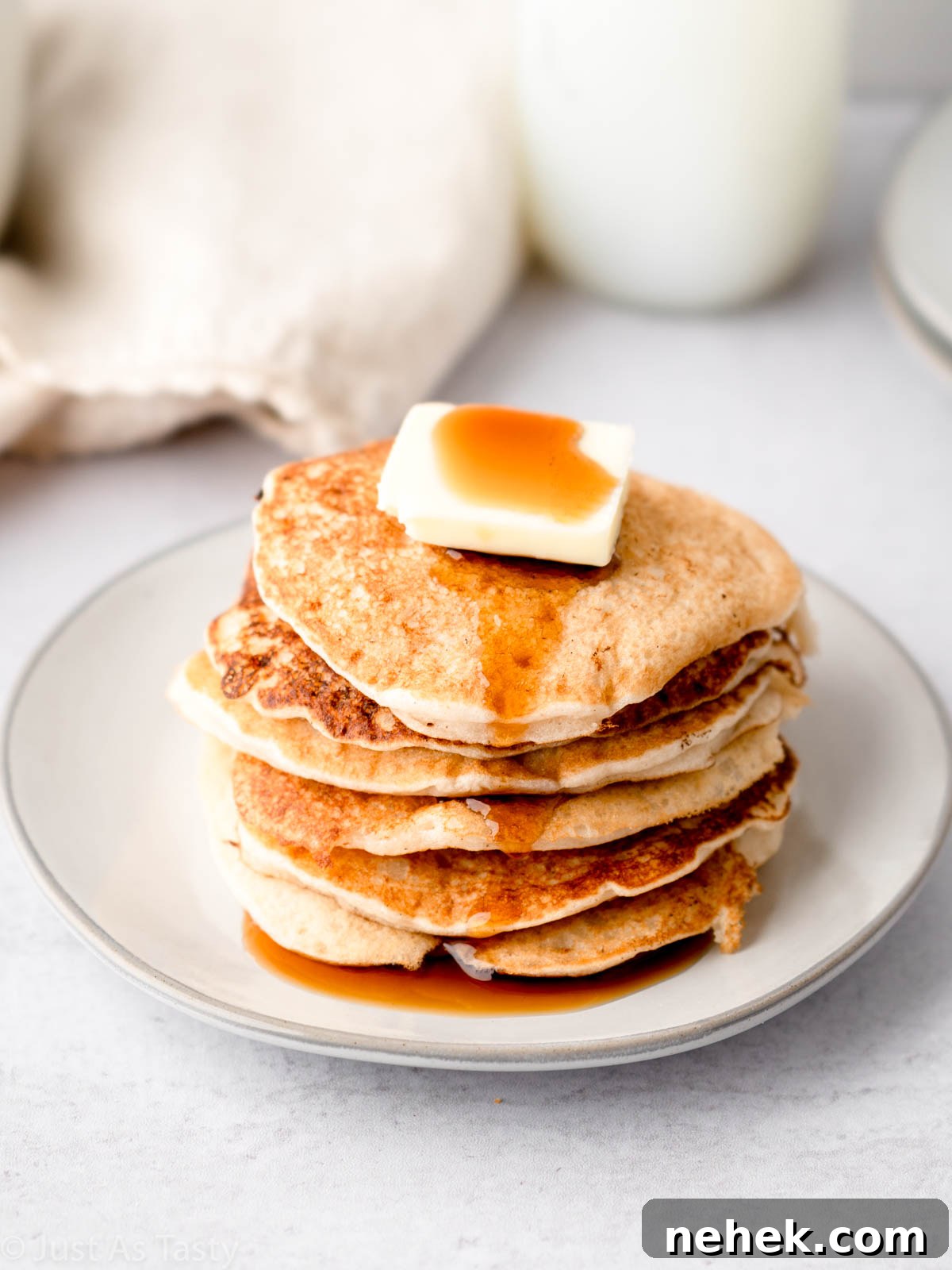Stack of gluten free pancakes on a plate.