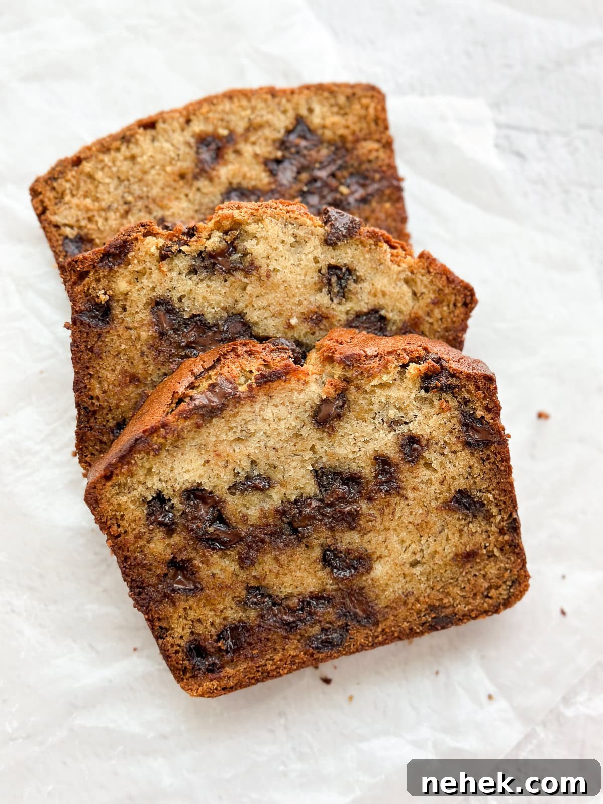 a few pieces of banana chocolate chip bread layered to see all the chocolate inside.
