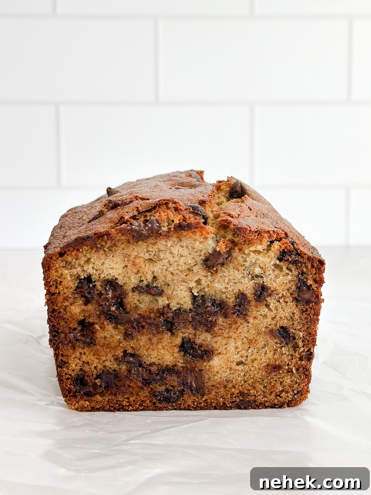 the whole loaf of banana chocolate chip bread cut in half to see the inside.