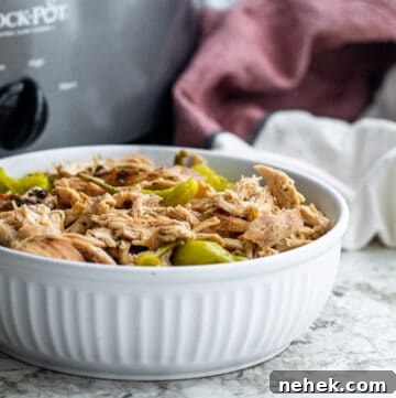 Slow-Cooker Mississippi Chicken with Creamy Sauce and Peppers 12 Chicken in white bowl on counter shot at an angle.