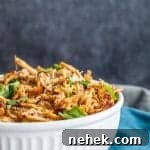 Large white bowl filled with shredded pork.
