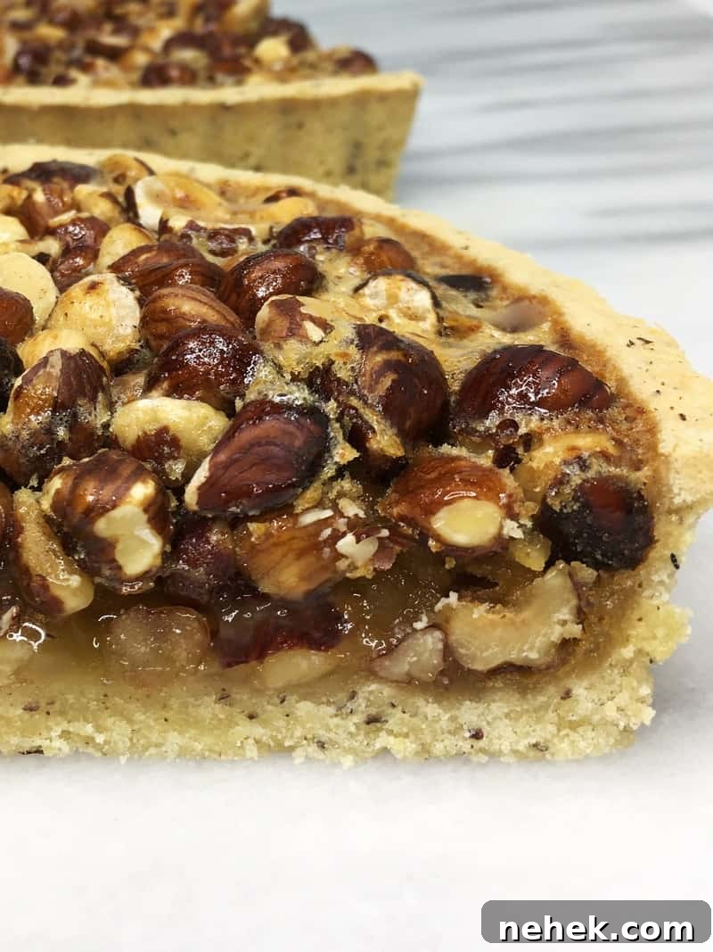 A slice of Hazelnut pie with the rest of the pie on background