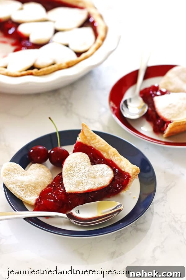 Classic Homemade Cherry Pie Recipe for Perfect Flaky Crust 2 Cherry Pie slices on red and blue rimmed plates with spoons. Pie in dish next to the plates.