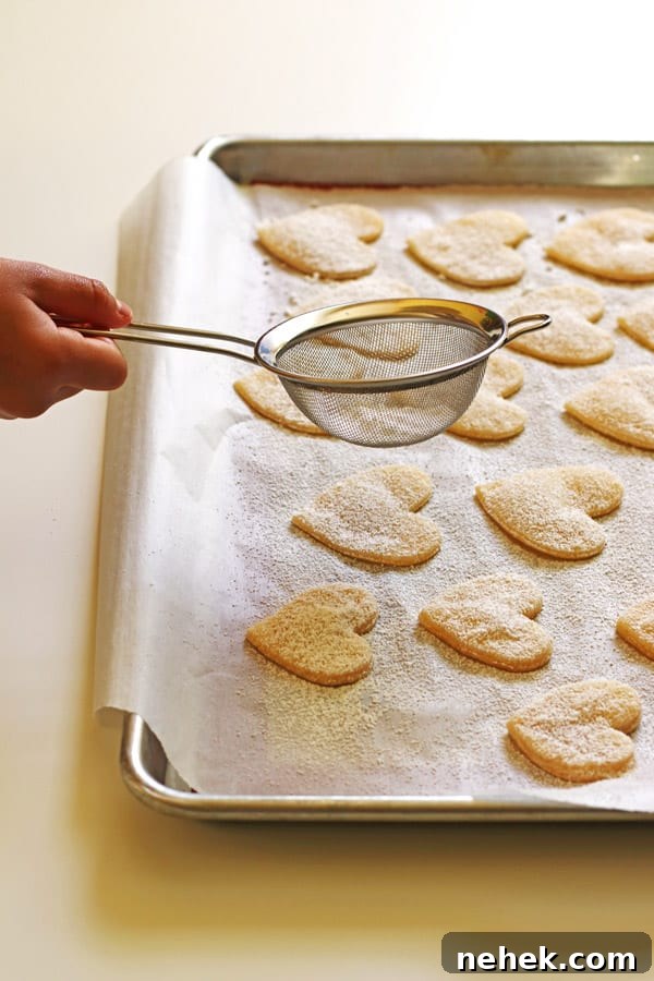Classic Homemade Cherry Pie Recipe for Perfect Flaky Crust 7 Pie crust cut into hearts on baking sheet getting sprinkled with powdered sugar