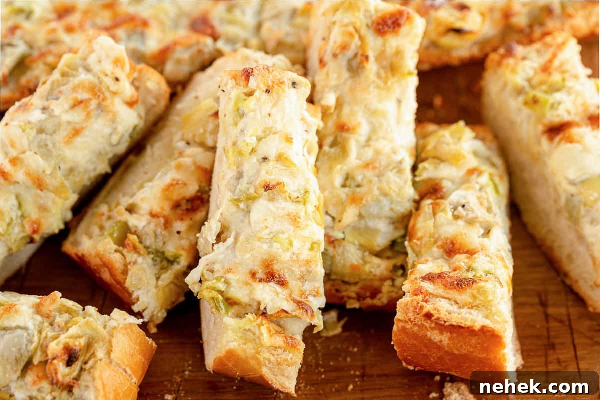 Sliced artichoke bread on a cutting board.