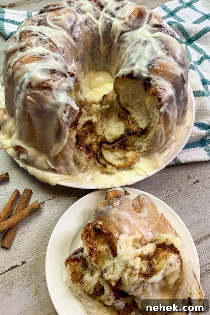 Pull-Apart Monkey Bread Recipe: Sticky Cinnamon Dinner Roll Pull-Aparts 2 Homemade monkey bread with a chunk pulled out on a plate.