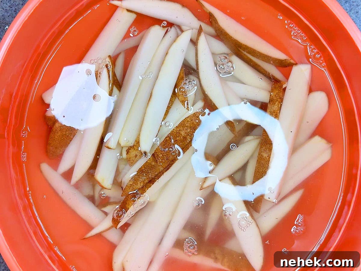 Crispy Oven-Baked French Fries Recipe for Perfect Crunch 4 Soaking cut potatoes in cold water.