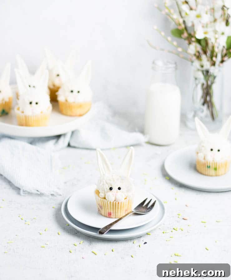 easter bunny cupcake on a plate with other cupcakes in the background