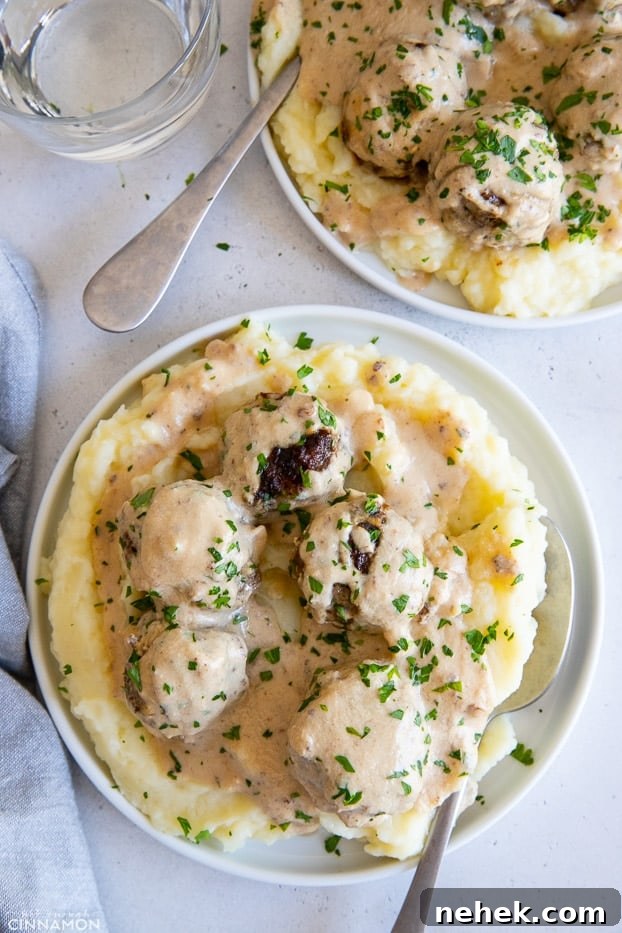 two servings of paleo Swedish Meatballs in dairyfree cashew gravy served over cauliflower mash 