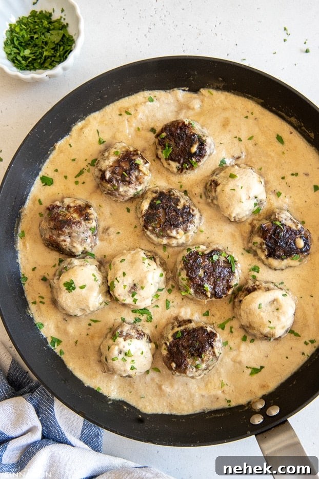 overhead shot of a skillet with paleo Swedish Meatballs in creamy cashew gravy 