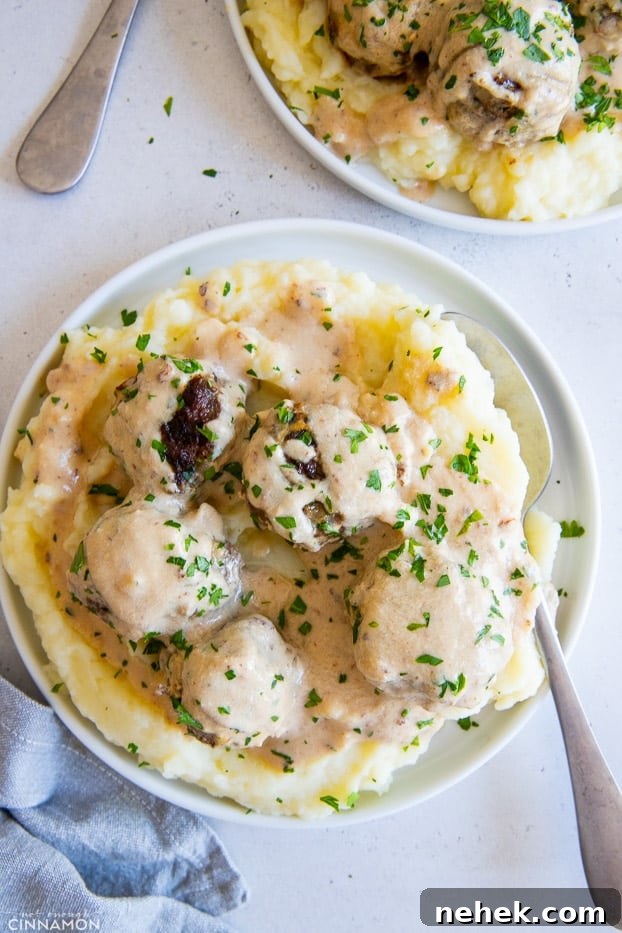 a plate with cauliflower mash topped with Paleo beef meatballs and dairyfree gravy