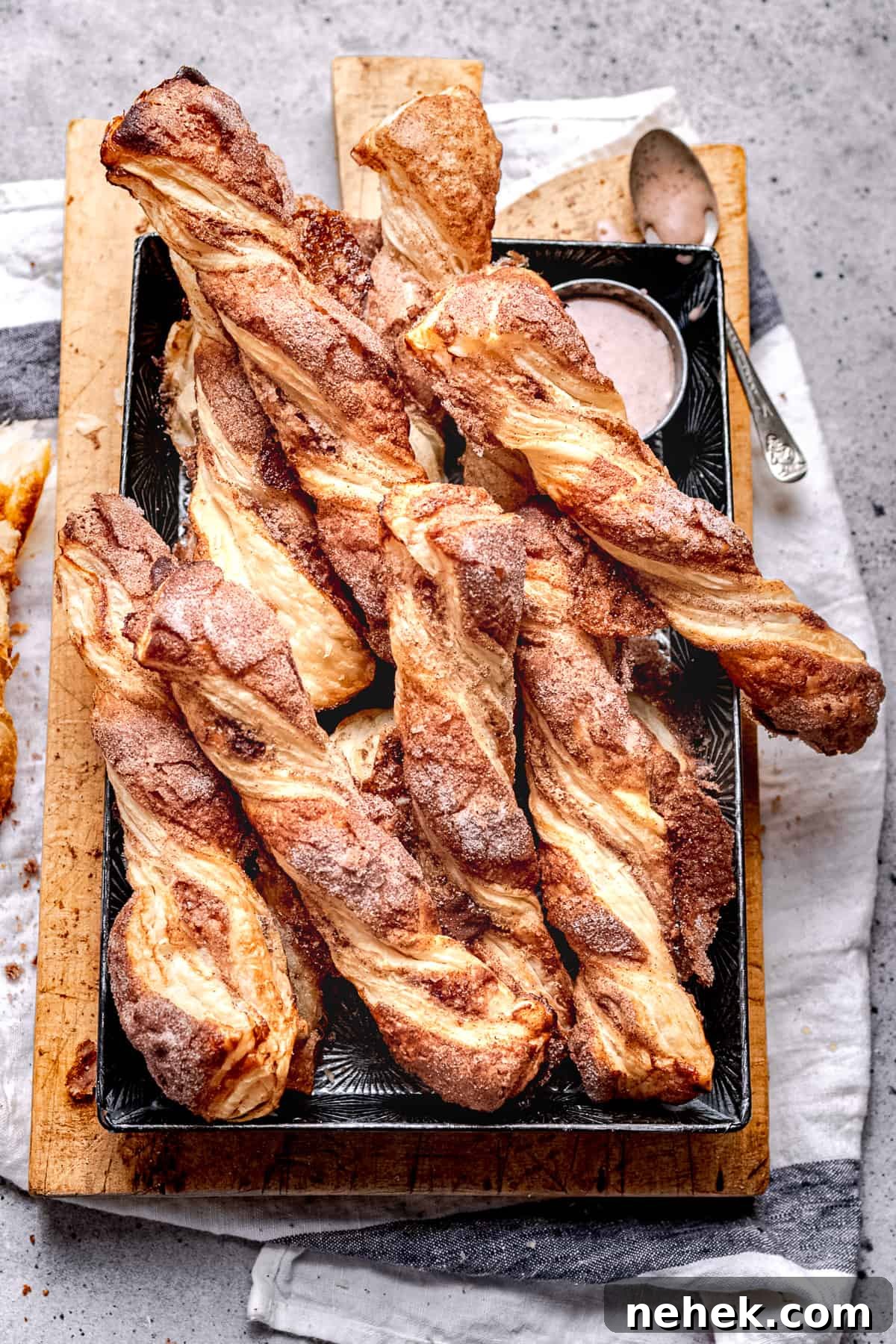 Cinnamon Puff Pastry Twists: Simple Sweet Pastry Recipe 2 Cinnamon puff pastry twists in a baking tray.
