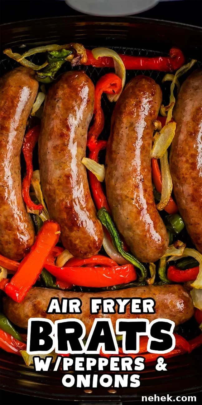 Four air-fried bratwursts rest on a bed of sliced peppers and onions. Text overlay reads: "Air Fryer Brats with Peppers & Onions.