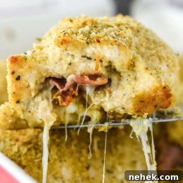 Chicken rollatini being lifted out of baking dish on spatula.