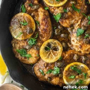 overhead shot of chicken piccata in cast iron skillet