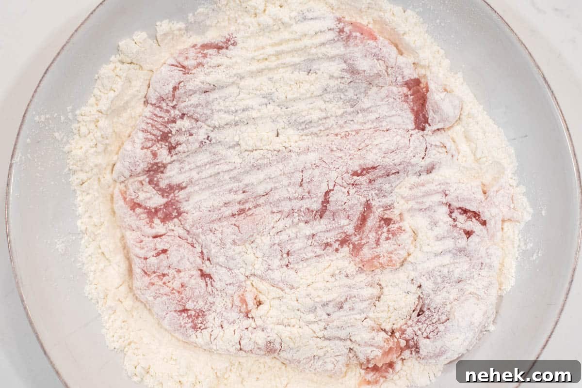 Chicken dredged in flour.