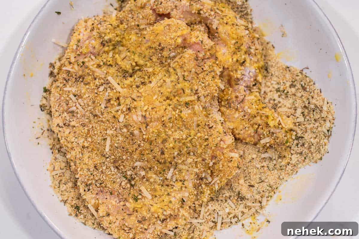 Chicken dredged in breadcrumb mixture.