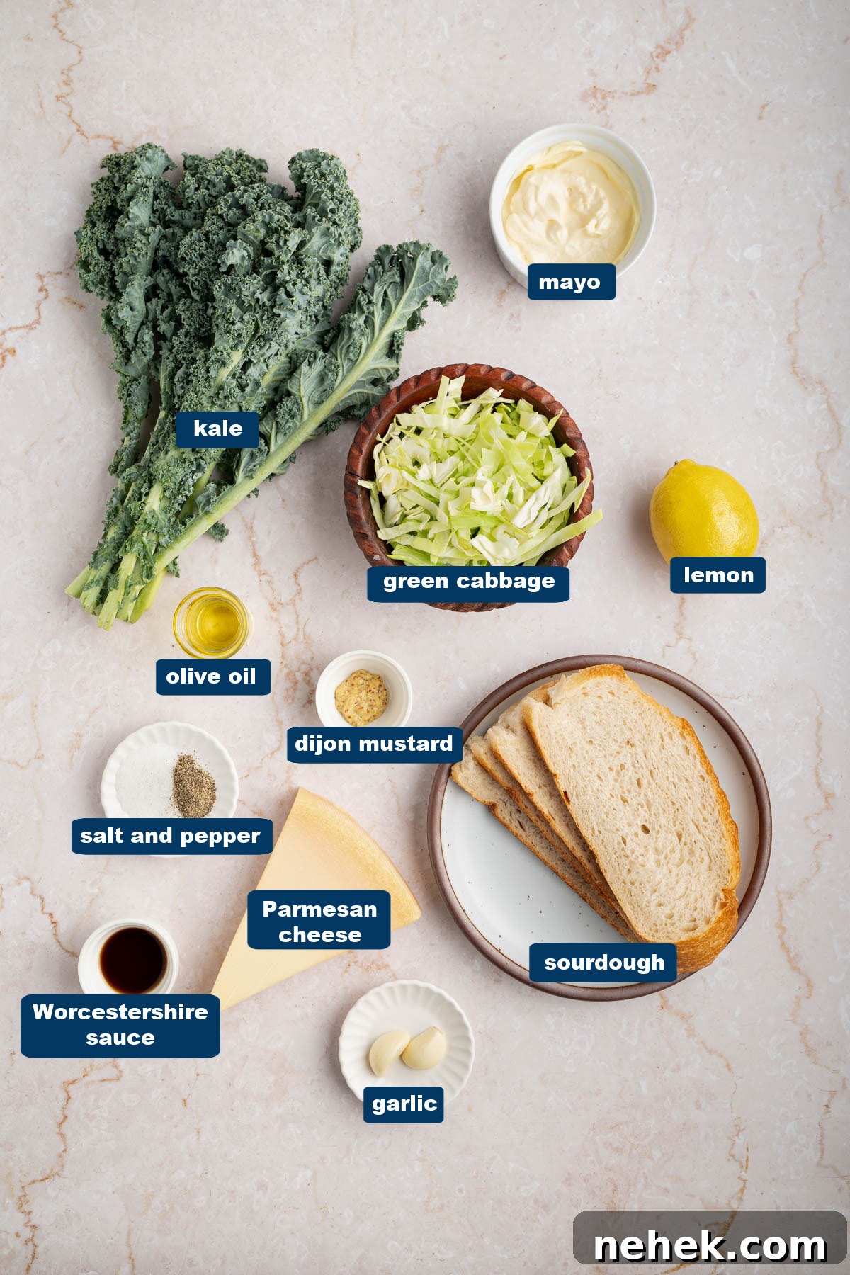All of the ingredients for kale caesar salad in bowls on a white countertop.