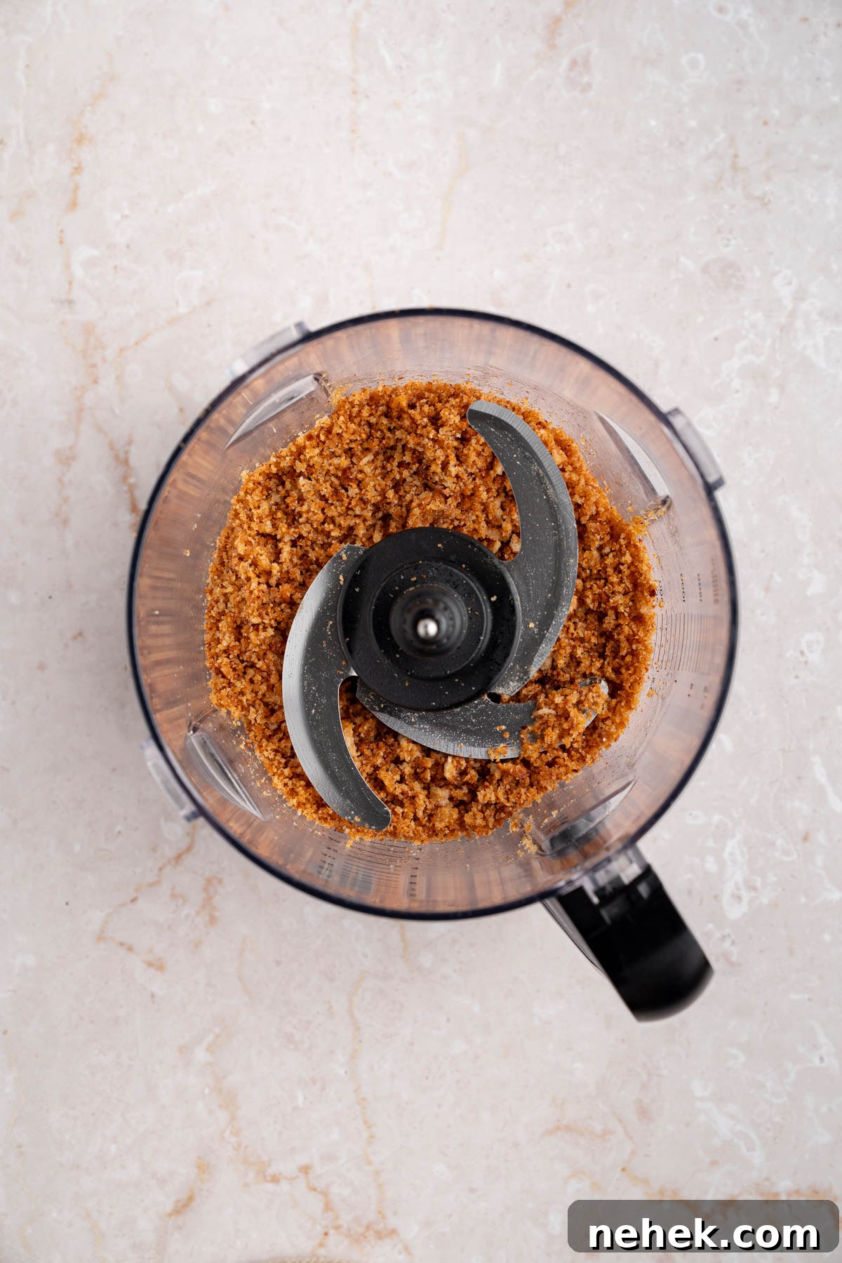 The breadcrumbs in a food processor bowl.