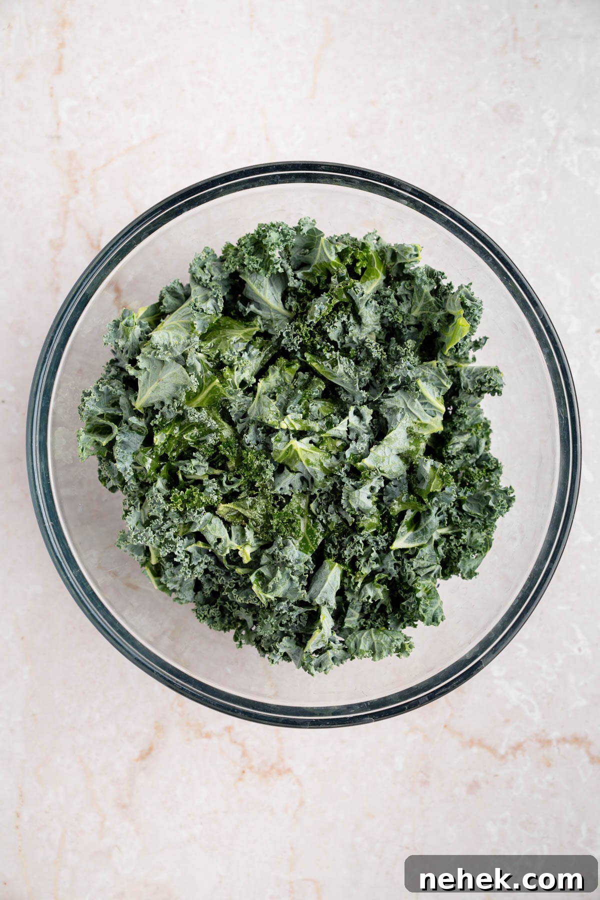 The kale in a large bowl before massaging.