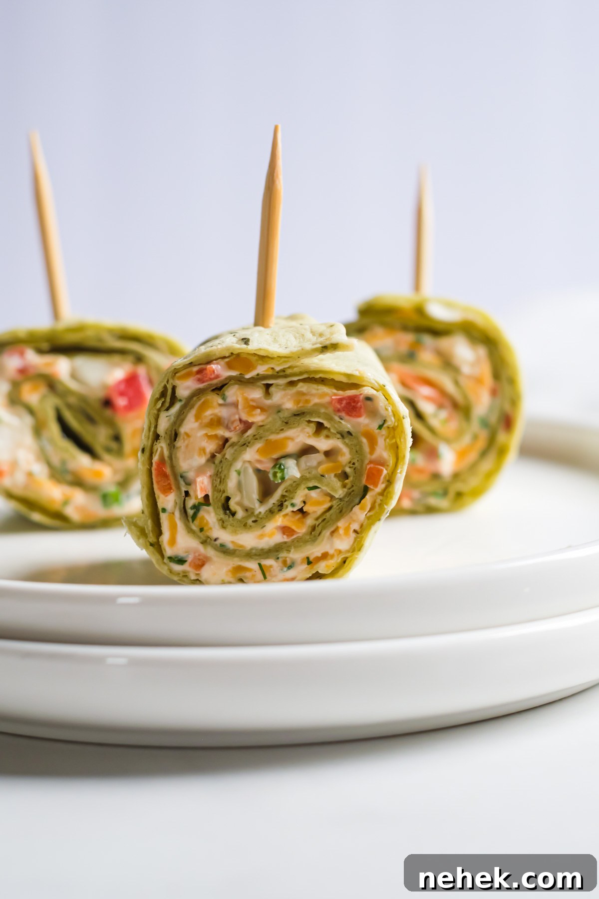 Crunchy Veggie Pinwheels with Cream Cheese and Herbs 13 three pieces of the pinwheel served with toothpicks