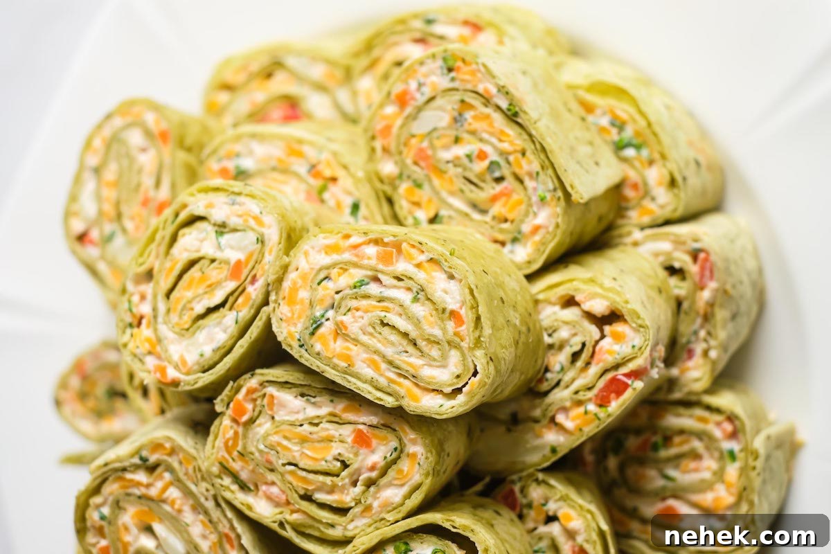 Crunchy Veggie Pinwheels with Cream Cheese and Herbs 14 close up view of the stacked pinwheel slices