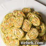 Crunchy Veggie Pinwheels with Cream Cheese and Herbs 15 the completed veggie pinwheels recipe on a white plate