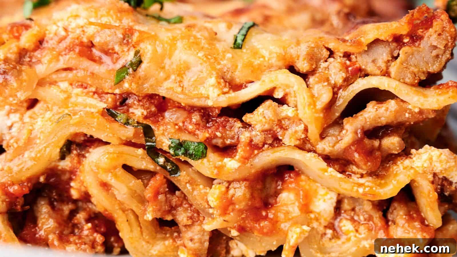 15 Delicious Easter Recipes to Make Your Celebration Shine 15 Close-up of a delicious slice of lasagna, showcasing layers of pasta, ground meat, tomato sauce, ricotta cheese, and garnished with chopped basil.