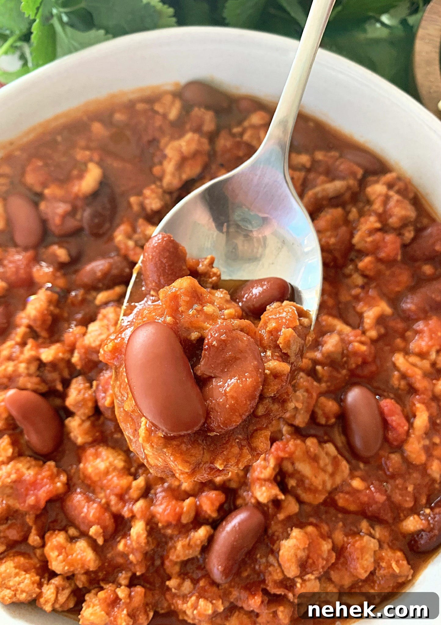 Slow-Cooker Turkey Chili Recipe: Hearty, Flavorful Meal 4 crockpot turkey chili - close up view with chili in spoon