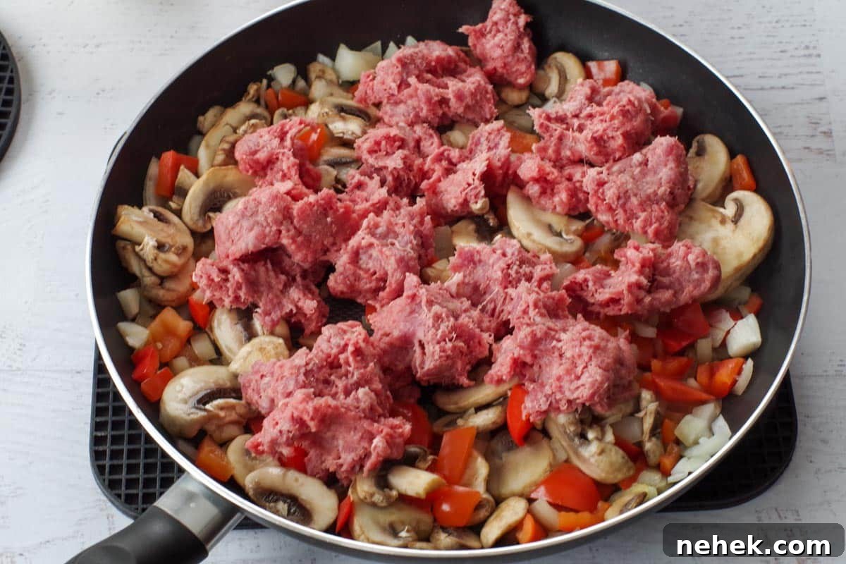 Low-Carb Pizza Casserole with Veggies and Mozzarella 5 ground beef added to vegetable mixture in skillet