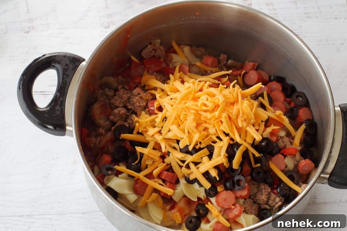 Low-Carb Pizza Casserole with Veggies and Mozzarella 7 ground beef mixture in pot with other ingredients (cheese etc0