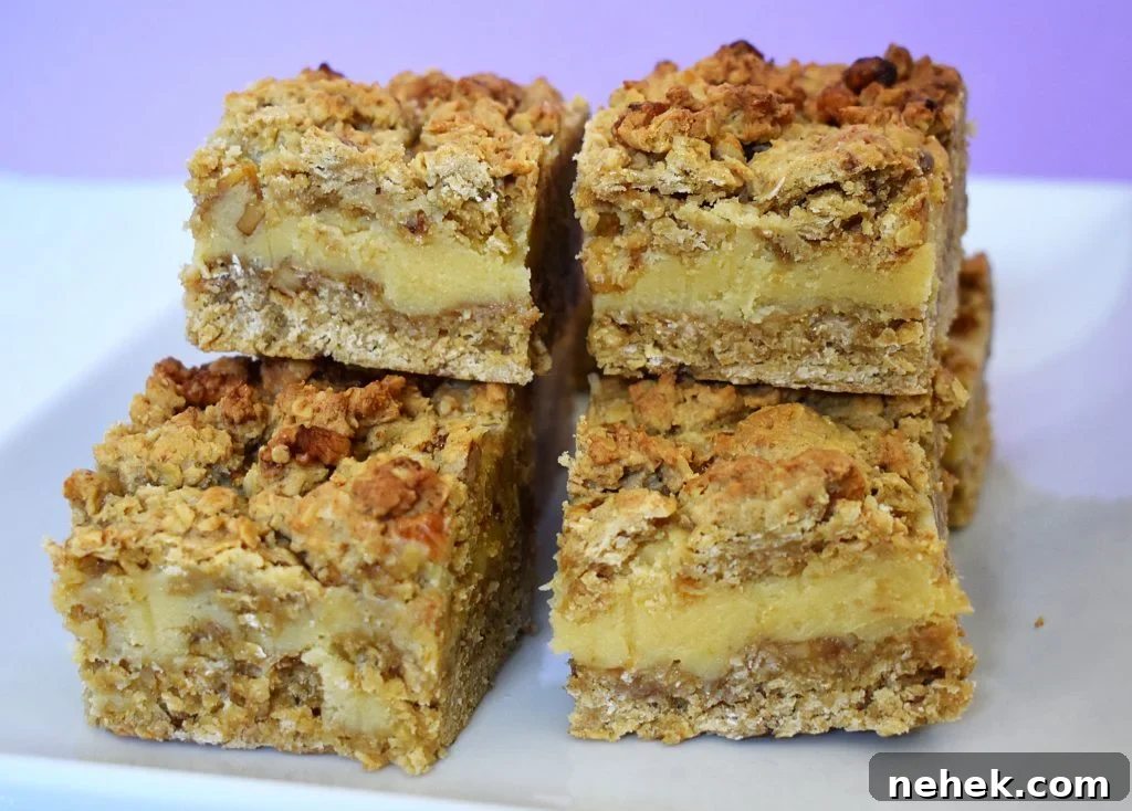 Pieces of walnut caramel slices on a plate and purple background.