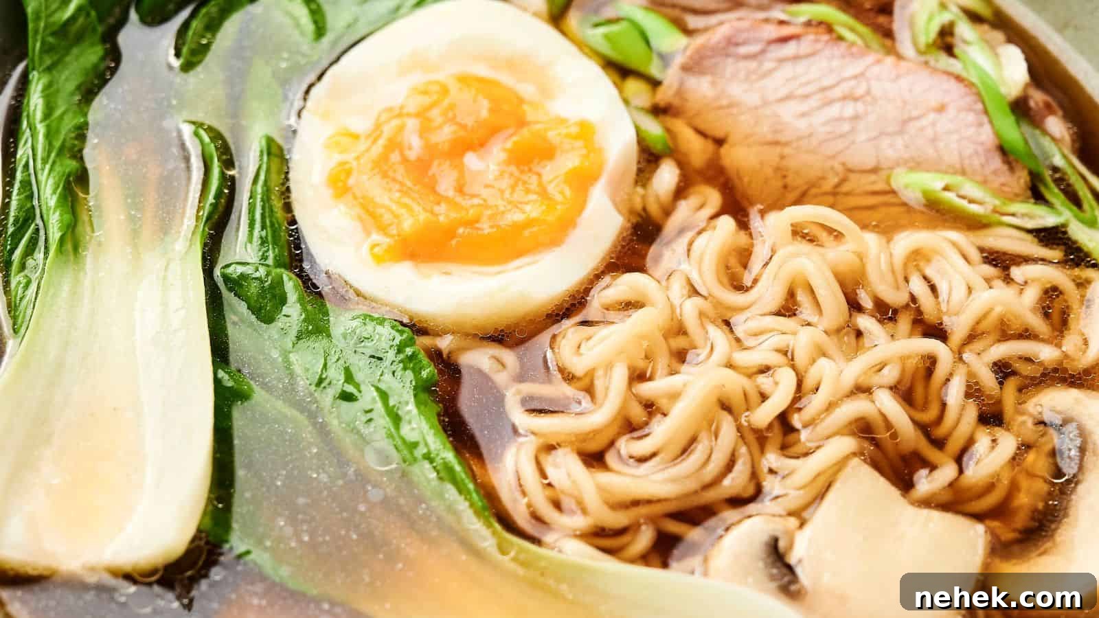 Close-up of a bowl of ramen with noodles, a halved boiled egg, sliced meat, green leafy vegetables, and mushrooms in broth.