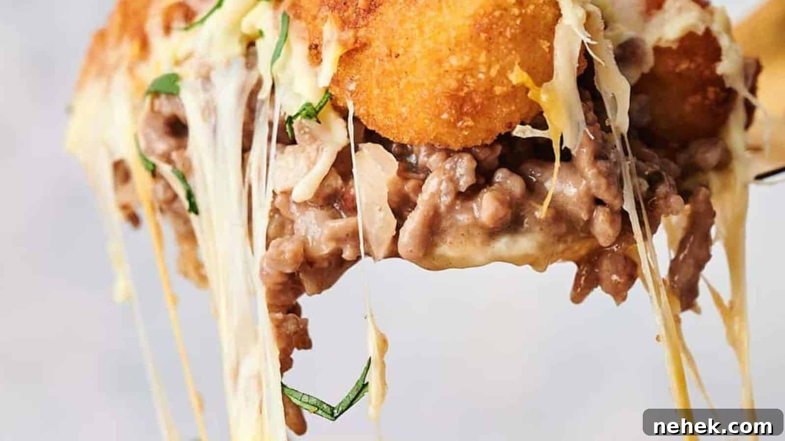 A serving of tater tot casserole on a spoon.