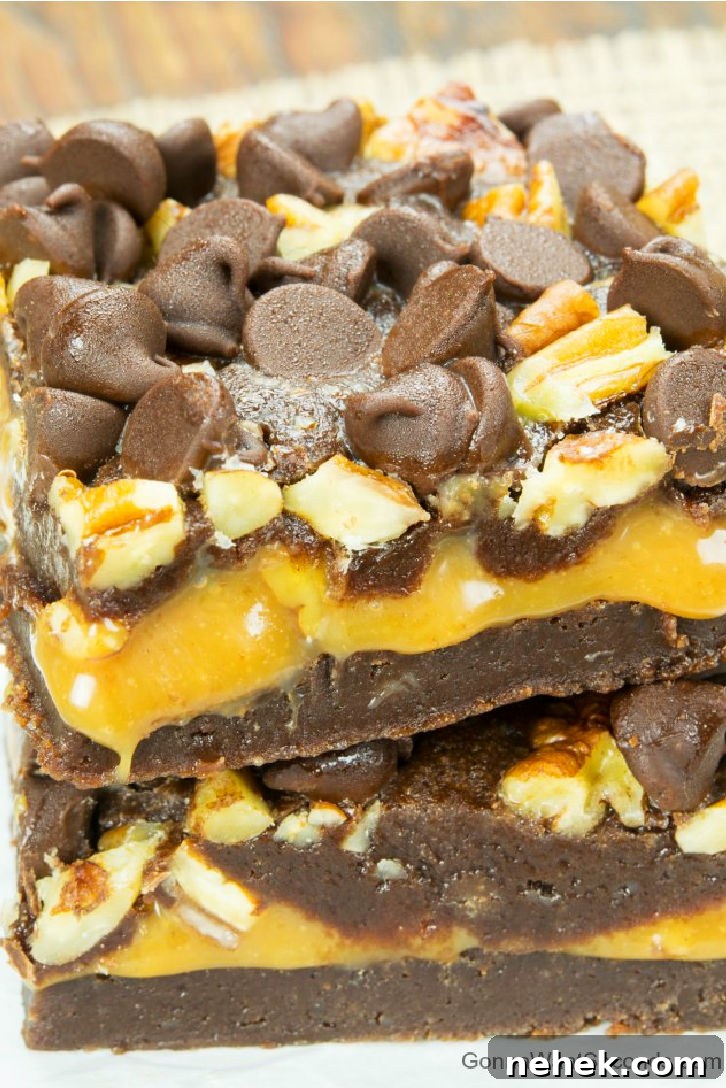 Caramel brownies are your tickets to brownie bliss – fudgy brownies wrapped around a thick, caramel layer, with crisp pecans and chocolate chips. slices of Caramel brownies with chocolate chips and pecans on top