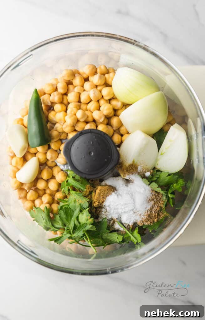 An overhead view of the ingredients in gluten-free falafel in a food processor prior to mixing.