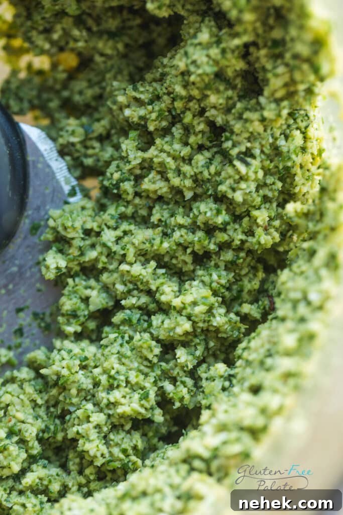 A close up of gluten-free falafel mixture in a food processor.