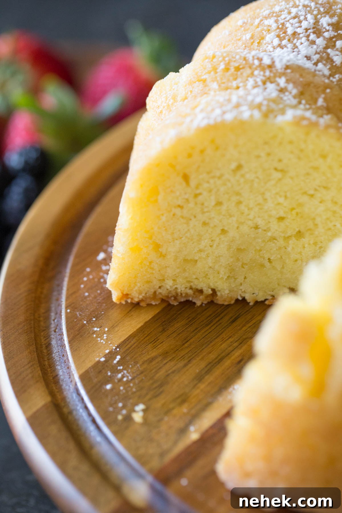 Classic Kentucky Butter Cake Recipe: Moist Southern Pound Cake 4 Close up view of Kentucky Butter Cake on wooden cake stand.