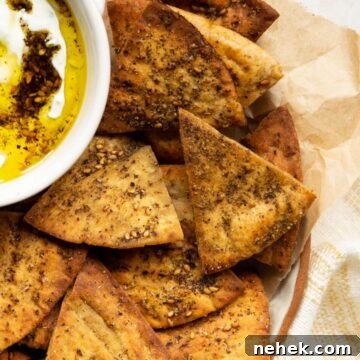 Crispy, fresh homemade air fryer pita chips piled in a bowl, golden and perfectly seasoned.