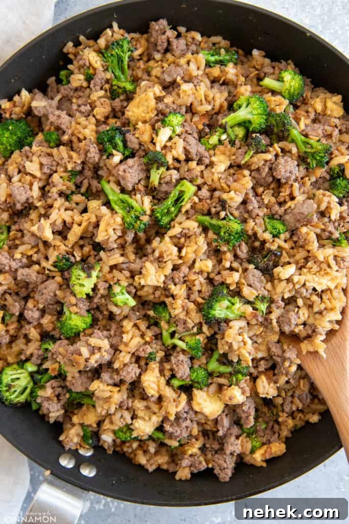 Ground Beef and Broccoli Fried Rice Recipe for Weeknight Dinner 8 Healthy Asian Beef and Broccoli Fried Rice being stir-fried in a big skillet