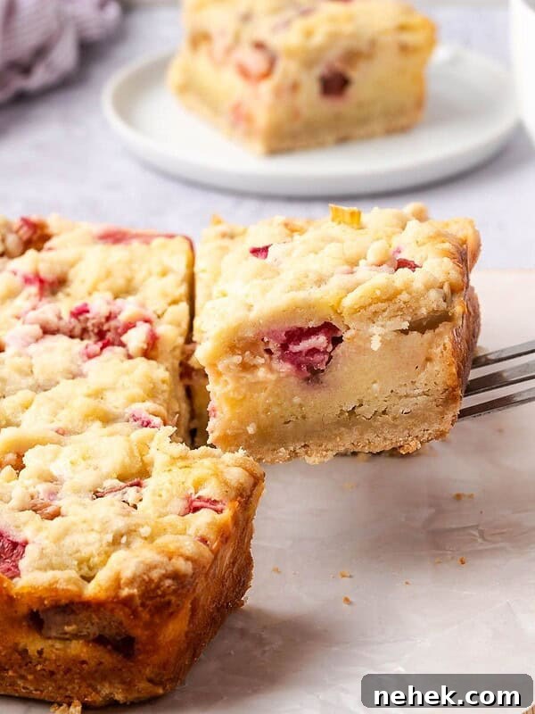 Sliced rhubarb custard bars on a wooden board.